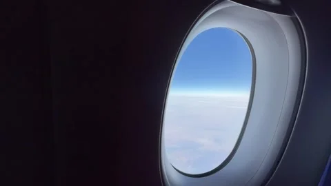 Looking out of a flight window mid-air Video stock 302474350