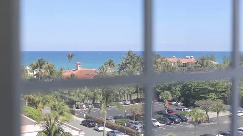 Looking out Hotel Window onto Palm Beach Island Stock Footage 76484140