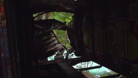 Looking Out from Inside a Crumpled Derailed Boxcar at a Turquoise River Stock Footage 347901386