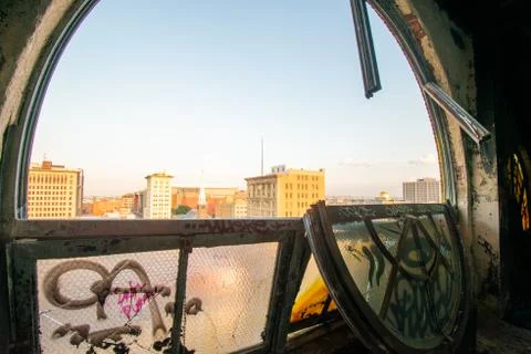 Looking Out a Large and Broken Arched Window at a City Skyline in an Abandone Stock Photos