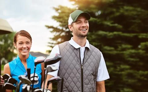 Looking out over the front nine. an affectionate young couple spending a day on Fotos Stock