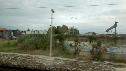Looking out from Passing Railroad Train. Transport / Europe / Italy / Travel. Stock Footage 130927878