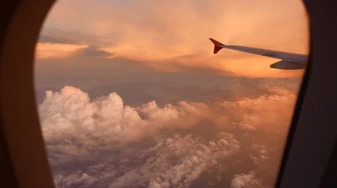 Looking out plane window, amazing reddish clouds downwards and up, sunset Stock Footage 50541968