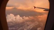 Looking Out Plane Window, Amazing Reddish Clouds Downwards And Up, Sunset Stock Footage