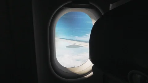 Looking Out Plane Window, Amazing Clouds and blue sky Downwards And Up Stock Footage 115327732