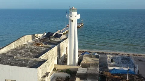 Looking out to see the camera rises behind a lighthouse and reveals a pier. Stock Footage 104719988