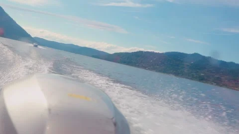 Looking out from the stern of a fast moving motor boat to it's large bright Stock Footage 278000035