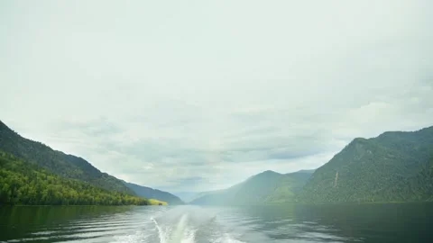 Looking out from the stern of a fast moving motor boat to it's large bright Video stock 278000417
