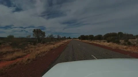 Looking out through the windscreen as a car races along an outback country Stock Footage 202487781