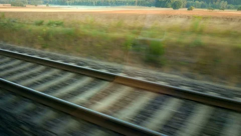 Looking out to tracks of a driving train Stock Footage