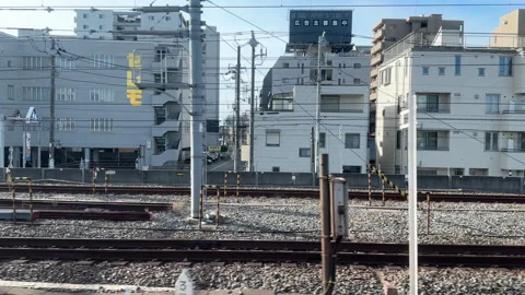 Looking out from train at typical japanese city, arriving at station Stock Footage 252721825