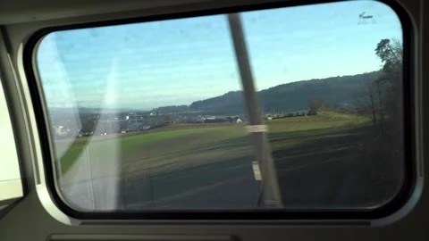 Looking out a train window to reveal swiss alps Stock Footage 263815673