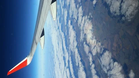 Looking out the window of an airplane while flying in a wing with a beautiful Stock Footage 166209299