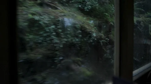 Looking out the window at a cliff face from a vintage steam train Stock Footage 128359037