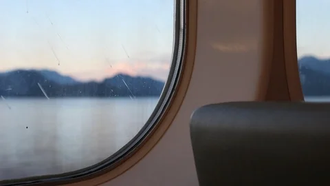 Looking Out The Window Of A Ferry With Mountains In The Background Stock Footage 99940224