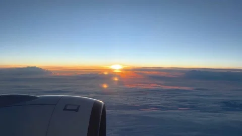 Looking out of window of flying at sunrise airplane. Point of view 4k video  Stock Footage 231758695