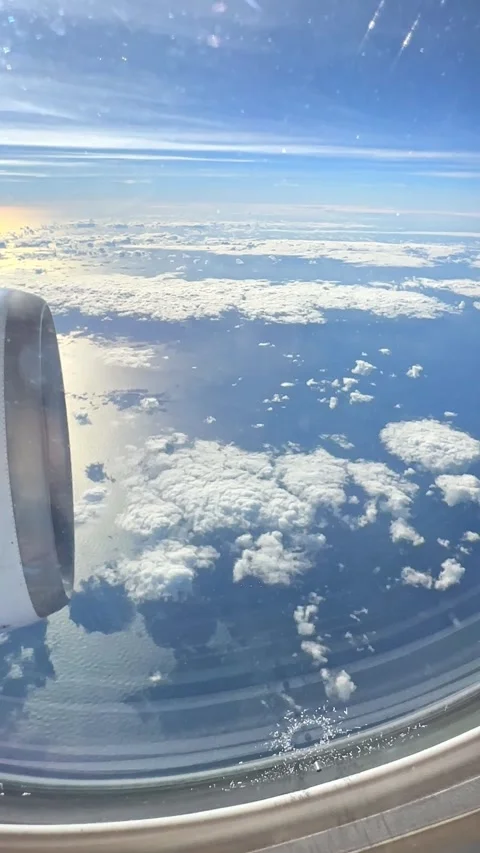 Looking out of window of flying at sunrise airplane. Point of view 4k video  Stock Footage 265889280