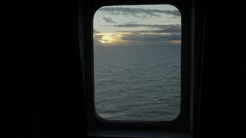 Looking out the window of a passenger cabin at a cruise ship watching the ocean Stock Footage 152420206
