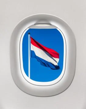 Looking out the window of a plane to the flag of Netherlands, travel concept Foto stock