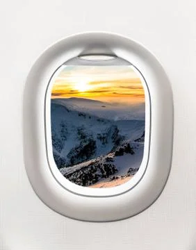Looking out the window of a plane to the winter mountains Foto stock