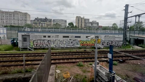 Looking out of the window of an SNCF train traveling through Paris passing Video stock 248424784