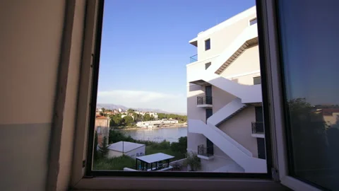 Looking out the window towards the Bacvice Beach in Split, Croatia with Stock Footage 199557345