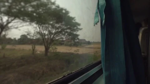 Looking out Window of Traveling Train at Farm Lands Rolling Past Stock Footage 79161331
