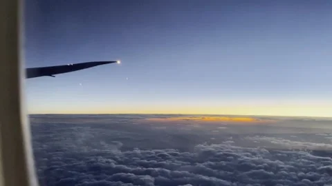 Looking outside from flight window at dawn, beautiful sunset, travel experience 스톡 동영상 255227051