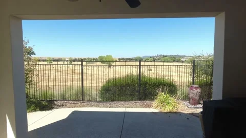 Looking outside a window to the backyard into a park reserve Stock-Footage 244487644