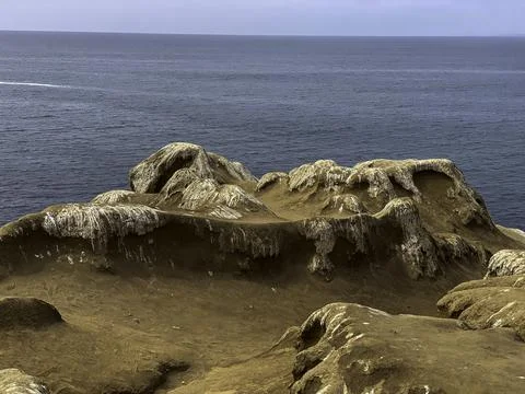 Looking over cliffs into the ocean Stock Photos