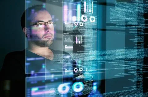 Looking over the data. Cropped shot of a young computer programmer looking Foto stock