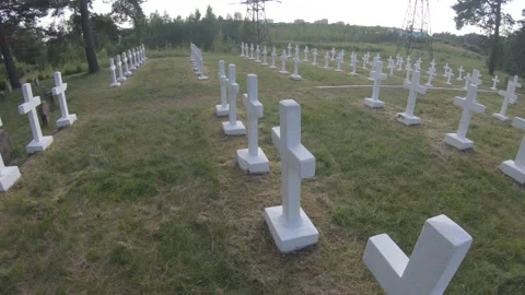 Looking over a Graveyard of White Crosses for Fallen Soldiers 4k60fps Stock Footage 135634126
