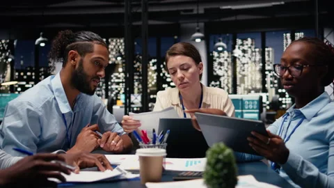 Looking over paperwork documents, diversity and team of employees Stock Footage 334041156