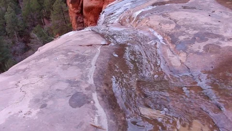 Looking over the red rock waterfall Stock Footage 93996014