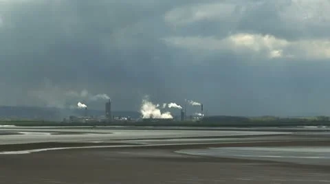 Looking over river estuary towards petrochemical plant 2 Stock Footage 10892830