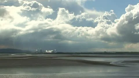 Looking over river estuary towards petrochemical plant Stock Footage