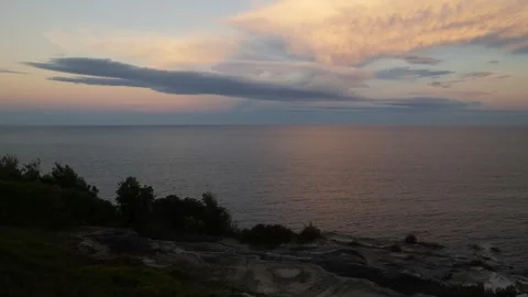 Looking over a Sydney cliff top at the sea and beautiful clouds 6K Stock Footage 305360864