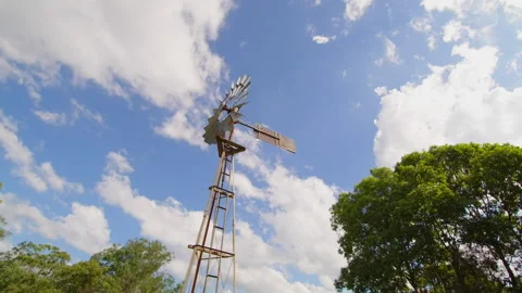 Looking up panning shot of a water bore windmill. Stock Footage 181456470