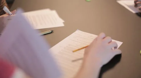 Looking at paper and somebody besides taking notes Stock Footage 65370763