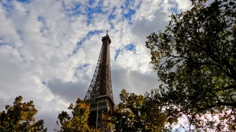 Looking up at the Paris Eiffel Tower next to trees Stock Footage 227932605