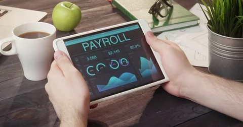 Looking at payroll records using digital tablet at desk Stock Footage 80702245