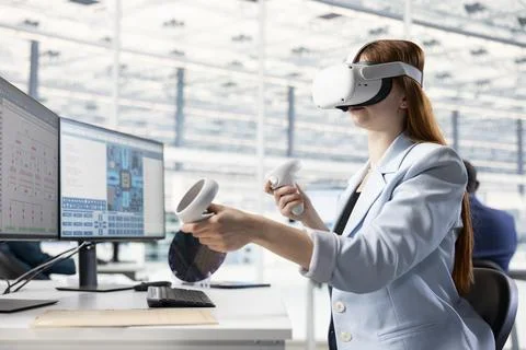 Looking at PCB layouts, VR headset and researcher in semiconductor factory Stock Photos