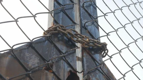 Looking up perspective of weathered chain link fence Stock Footage 328335547