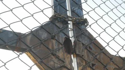 Looking up perspective of weathered chain link fence Stock Footage 328982948