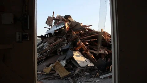 Looking at a pile of trash through the doorway of a fire station Stock Footage 94695931
