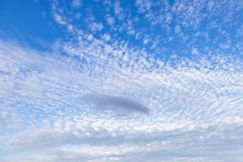 Looking up at pretty clouds and a blue sky Stock Photos