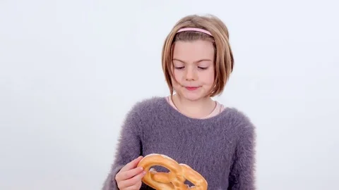 Looking at a pretzel and then biting into it Stock Footage 83724395
