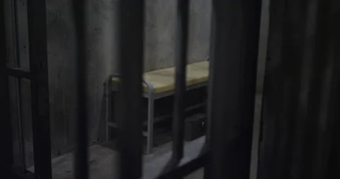 Looking into a prison cell showing the bed and empty floor Stock Footage 137823174