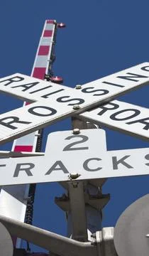 Looking up a railroad gate crossing Stock Photos