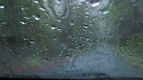Looking at rain falling on a car windshield from inside the car. Stock Footage 219769633